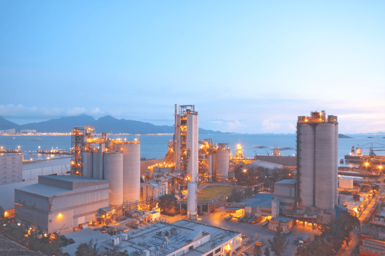 Aerial view of a modern cement manufacturing plant featuring industrial silos and engineering infrastructure.